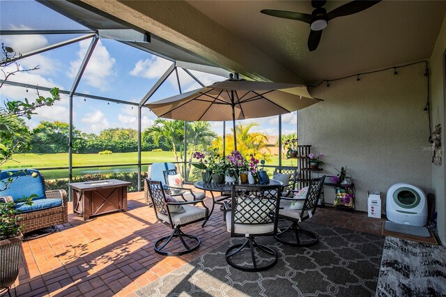 view of patio with glass enclosure and ceiling fan