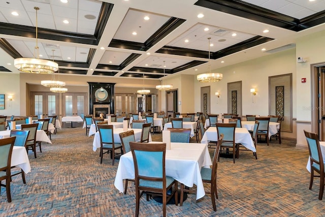 carpeted dining area with french doors, a towering ceiling, coffered ceiling, a large fireplace, and beam ceiling