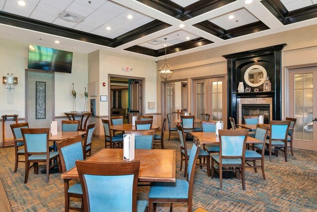 dining area with ornamental molding, coffered ceiling, beamed ceiling, a high ceiling, and a chandelier