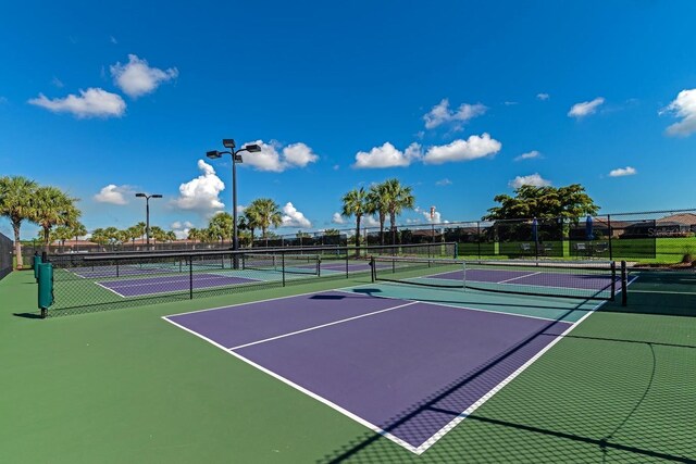 view of tennis court featuring basketball hoop