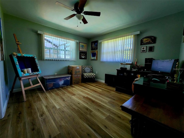 office space with light wood-type flooring, ceiling fan, and a wealth of natural light