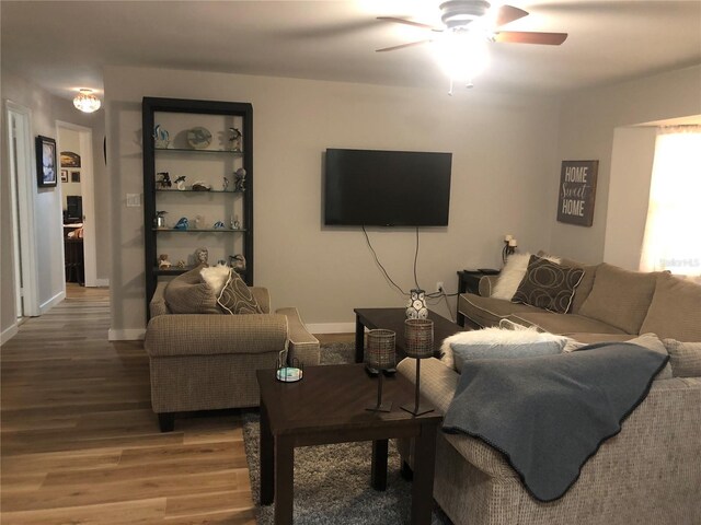 living room featuring ceiling fan and hardwood / wood-style floors