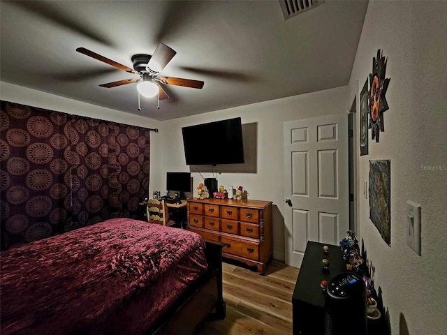 bedroom with ceiling fan and light hardwood / wood-style floors