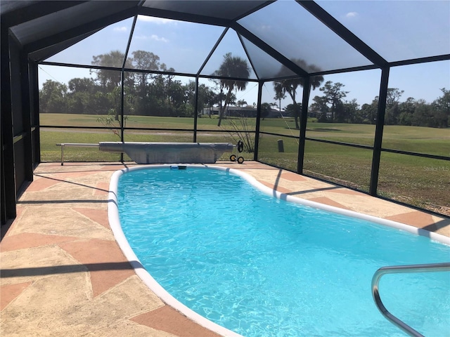 pool featuring a patio, a lawn, and a lanai