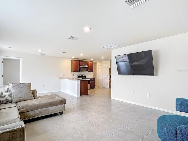 living room featuring sink and light tile patterned floors