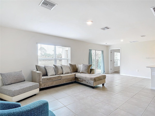 tiled living room with a healthy amount of sunlight