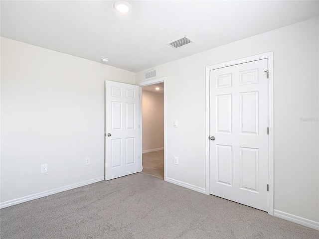 unfurnished bedroom featuring a closet and carpet floors