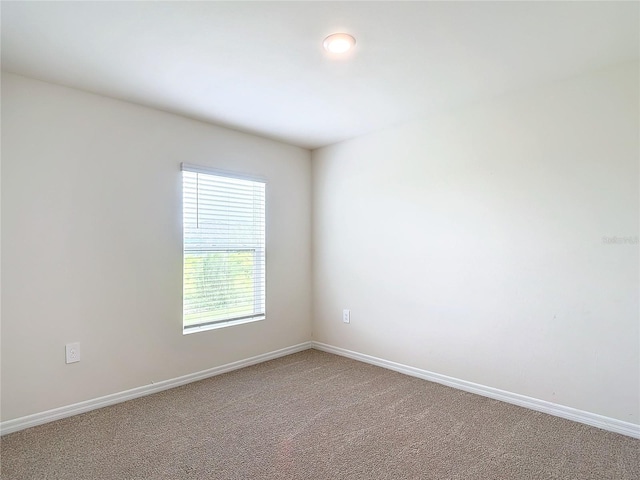 unfurnished room featuring baseboards and carpet flooring