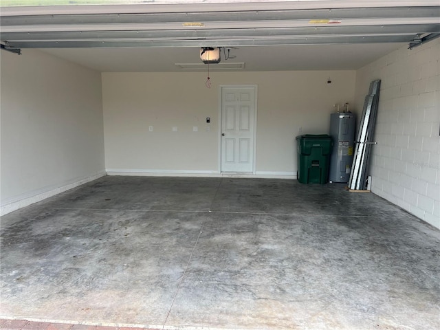 garage with water heater, baseboards, concrete block wall, and a garage door opener