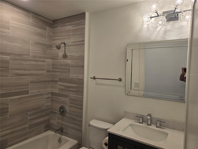 full bathroom featuring vanity, toilet, and tiled shower / bath