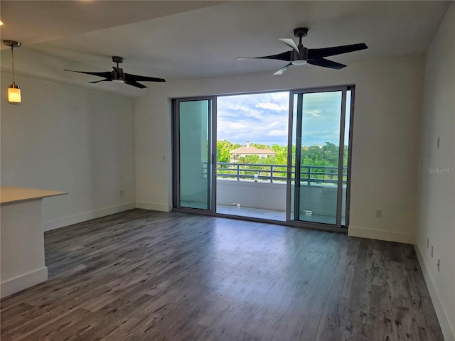 spare room featuring dark hardwood / wood-style floors and ceiling fan