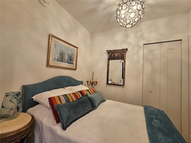 bedroom with a closet and a chandelier