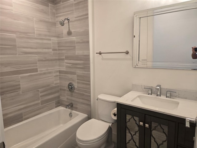 full bathroom featuring vanity, toilet, and tiled shower / bath