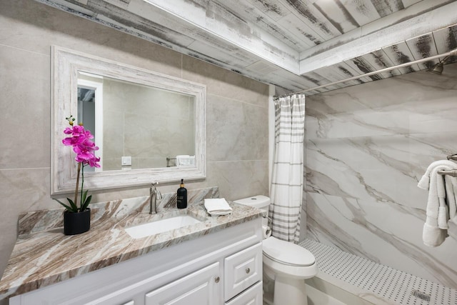 bathroom with toilet, vanity, walk in shower, and tile walls