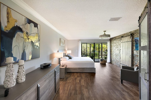 bedroom with dark wood-type flooring, a textured ceiling, crown molding, and access to outside