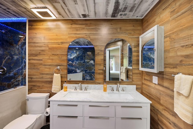 bathroom with wooden ceiling, wooden walls, toilet, and vanity