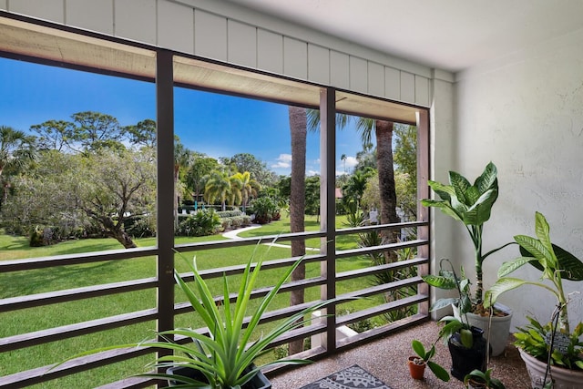 doorway to outside with plenty of natural light and carpet flooring