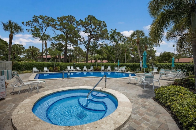 view of swimming pool with a community hot tub and a patio