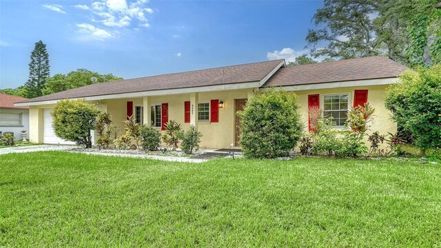 single story home featuring a garage and a front yard