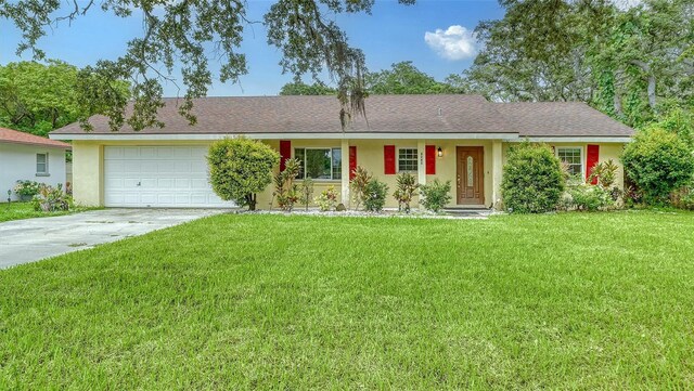 ranch-style home with a garage and a front lawn