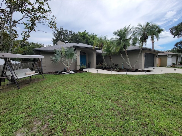 ranch-style home with a front yard and a garage