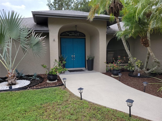 entrance to property with a lawn