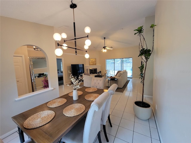 dining space featuring ceiling fan and light tile patterned floors