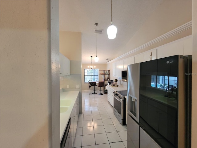 kitchen featuring decorative light fixtures, white cabinetry, and appliances with stainless steel finishes