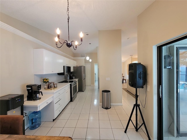 kitchen featuring light tile patterned flooring, an inviting chandelier, hanging light fixtures, stainless steel appliances, and white cabinets