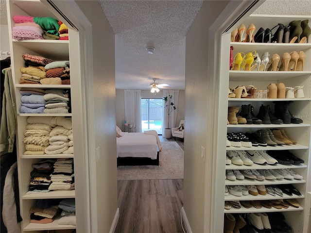 hall with a textured ceiling and hardwood / wood-style floors