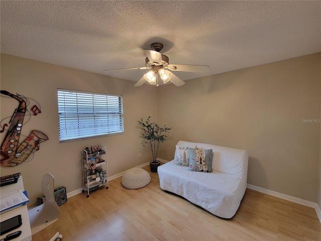 sitting room featuring a textured ceiling, ceiling fan, and hardwood / wood-style flooring