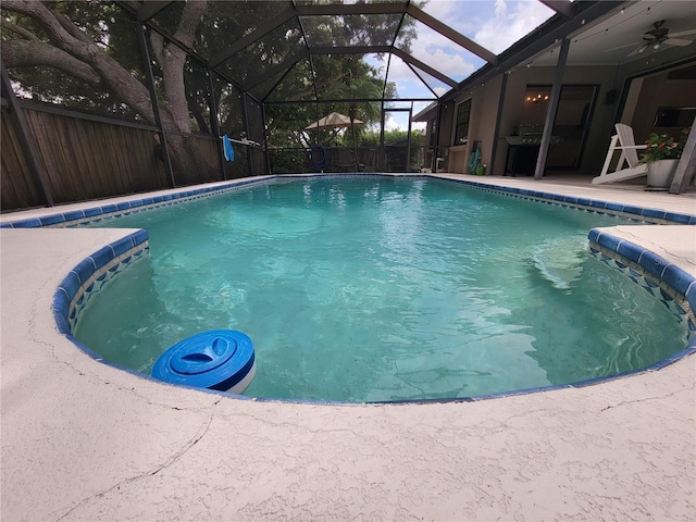 view of pool with a patio and glass enclosure