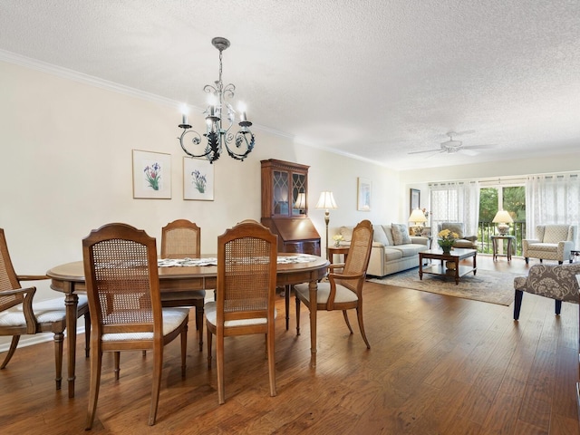 dining room with ornamental molding, dark hardwood / wood-style floors, and a textured ceiling