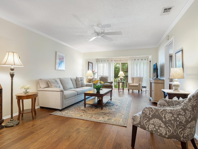 living room with ornamental molding, hardwood / wood-style floors, ceiling fan, and a textured ceiling