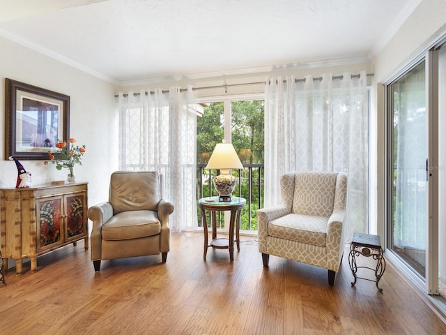 sitting room featuring crown molding and hardwood / wood-style flooring