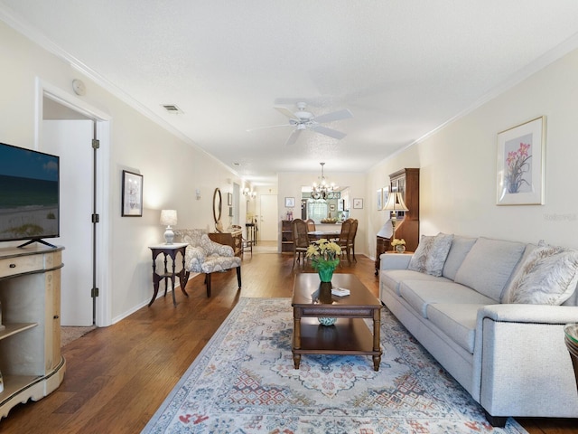 living room featuring crown molding, ceiling fan with notable chandelier, and hardwood / wood-style floors