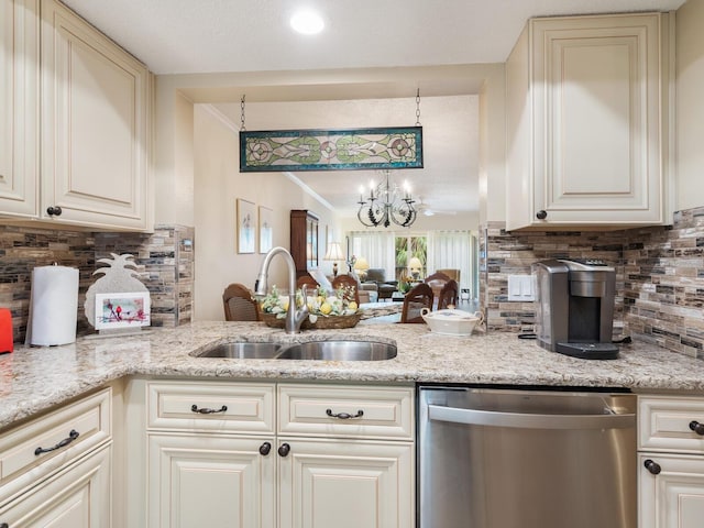 kitchen featuring sink, dishwasher, light stone countertops, decorative light fixtures, and cream cabinetry