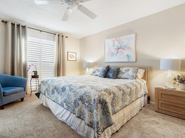 bedroom with light carpet, ceiling fan, and a textured ceiling