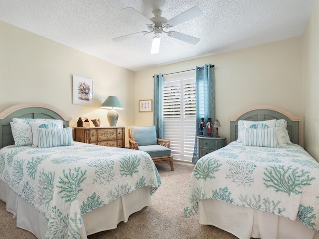 bedroom featuring ceiling fan, light colored carpet, and a textured ceiling