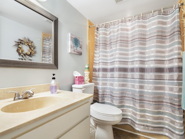 bathroom featuring vanity and toilet