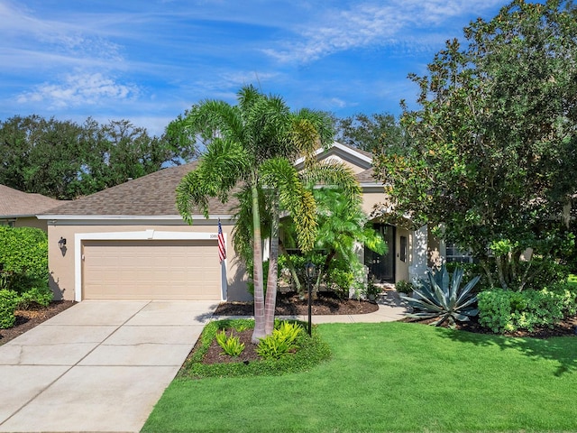 view of front of home with a garage and a front lawn