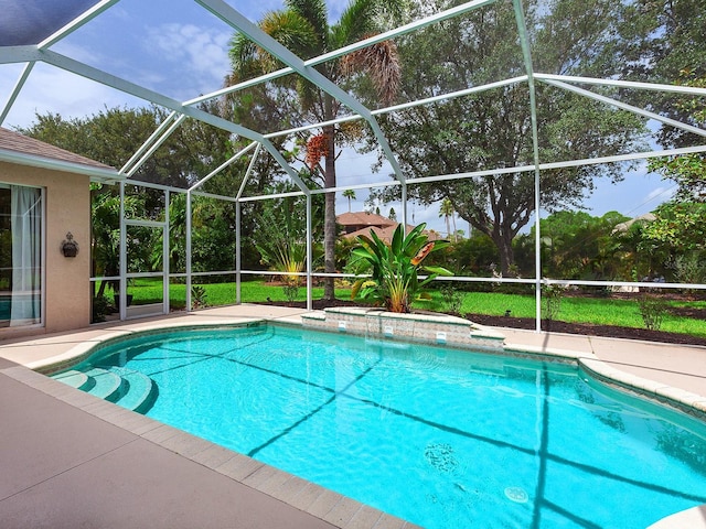 view of pool featuring a patio area and glass enclosure