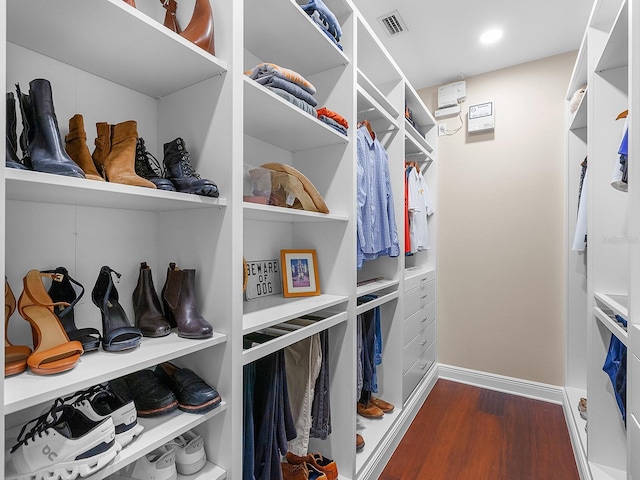 spacious closet featuring dark hardwood / wood-style floors