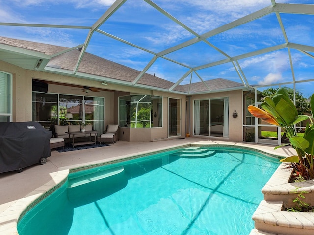 view of swimming pool featuring a lanai, ceiling fan, a grill, an outdoor living space, and a patio area