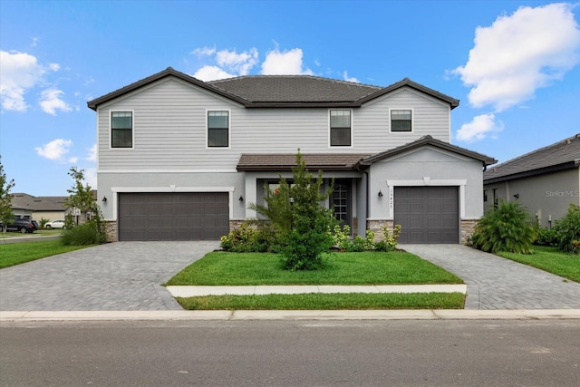 view of front of property featuring a front yard and a garage