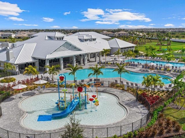 view of swimming pool with a playground and a water slide