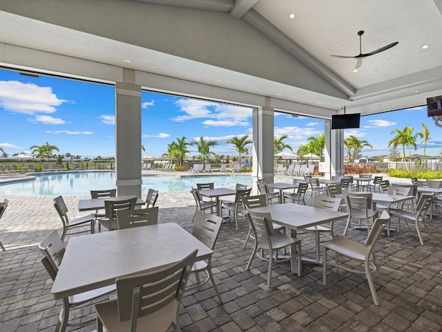 view of patio / terrace featuring a water view, ceiling fan, and a community pool