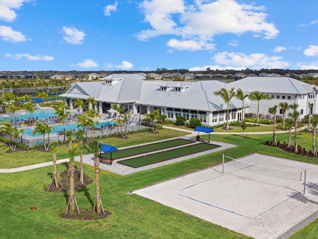 view of property's community featuring volleyball court and a lawn