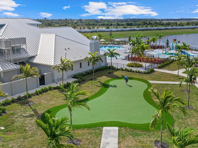 view of property's community with a water view and a swimming pool