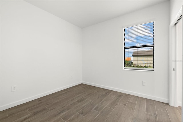 unfurnished room featuring hardwood / wood-style flooring